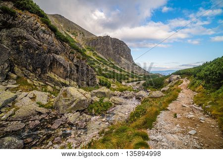 Hiking Trail near a Creek. Mountain Landscape on Cloudy Day. Mlynicka Valley High Tatra Slovakia.
