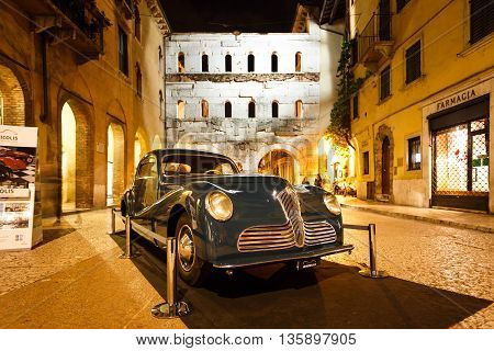 Verona Italy - May 07 2016: The retro car of Fiat nearby the Borsari gate at evening time