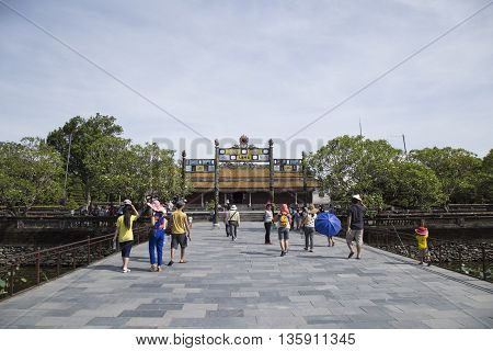 Hue, Vietnam - Jun 16, 2016: Visitors coming to see the Imperial Royal Palace of Nguyen dynasty at Ngo Mon gate. This gate is one of the forbidden city main gates.