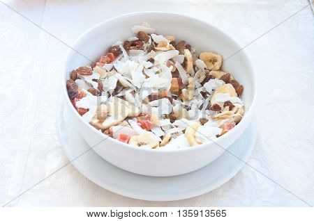 fantastic stuffed porcelain cup of cereal fruit and coconut flakes