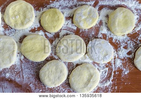 Grandma's curd pancakes with his hands ready for frying in a pan