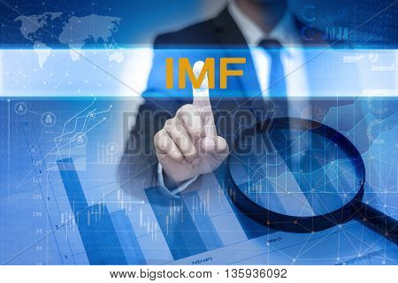 Businessman hand touching IMF button on virtual screen