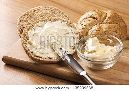 Close up A knife spreading butter on bread