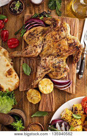 Grilled vegetables and chicken on wooden table overhead shot