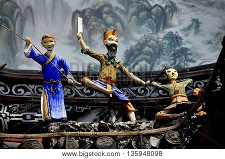 Dujiangyan China - April 8 2011: Carved and painted figures adorn the main entrance to the Ming Dynasty Nan Qiao covered bridge