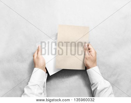 Hand holding blank envelope and kraft letter mockup, isolated. Arm hold clear brochure template mock up. Greeting card leaflet surface design. Invitation print display show. Reading writing envelope.