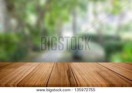 Selected focus empty brown wooden table and for product display montage big wooden table and garden.