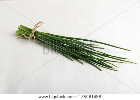 Fresh green chives on grey background