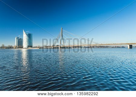 A view of the buildings and Vansu bridge on the banks of the Daugava River in Riga, Latvia at winter
