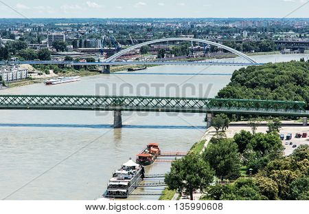 Bridges over the Danube river in Bratislava city Slovak republic. Old bridge and Apollo bridge. Ship transportation. Capital city of Slovakia. Travel destination.