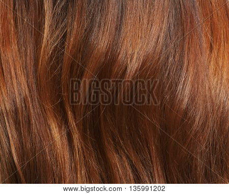 Long brown hair as background. Representation of woman's brownhair asbackground in studio. Hairdressing concept.