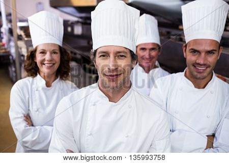 Portrait of smiling chef in commercial kitchen