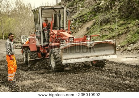 Ashtarak,armenia,19 Februar,2018: Builders Paving On A Tractor A New Bypass Road In The Highlands Of