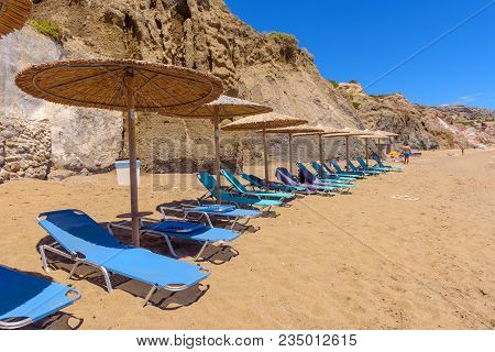 Milos, Greece - May 19, 2017: Sunbeds With Umbrellas On Beautiful Sandy Paleochori Beach On Milos Is