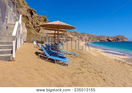 Sunbeds With Umbrellas On Beautiful Sandy Paleochori Beach On Milos Island. Cyclades, Greece.
