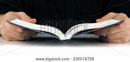 Man's Hands And Man Looking For Something In The Book
