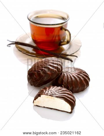 A Chocolate-coated Zefir With Tea. Isolated On White Background.