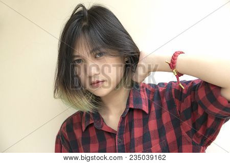 Portrait Of Asian Girl With Looking At Camera On White Background.
