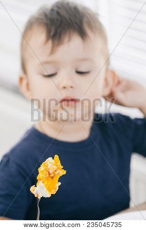 A Child In The Kitchen Eats Eggs Or Omelets In The Afternoon