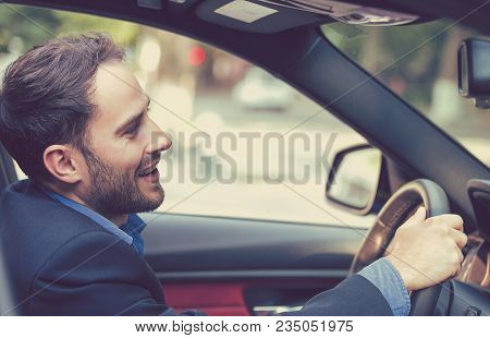 Happy Man With Hands On Wheel Driving New Car