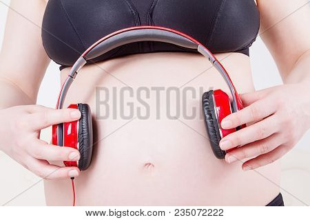 Image Of Pregnant Woman Touching Her Big Belly. Close Up. Motherhood, Pregnancy, People And Expectat