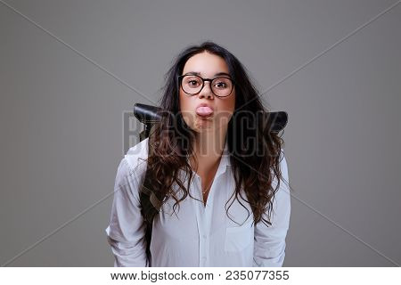 Positive Young Traveler Female With Leather Backpack Shows Her Tonque.