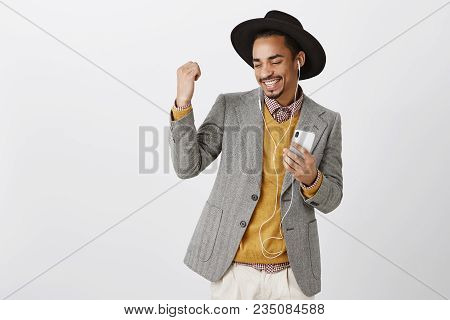Boost Of Courage Thanks To Great Song. Attractive Dark-skinned Boyfriend Getting Ready On Date, Hold