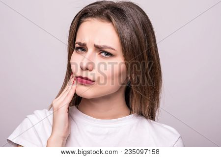 Teeth Problem. Woman Feeling Tooth Pain. Closeup Of A Beautiful Sad Girl Suffering From Strong Tooth