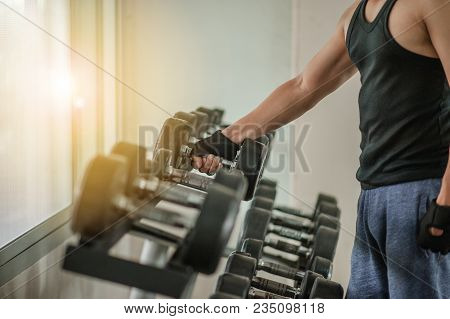 Rows Of Dumbbells In The Gym With Hign Contrast And Monochrome Color Tone.