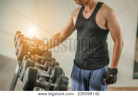 Rows Of Dumbbells In The Gym With Hign Contrast And Monochrome Color Tone.