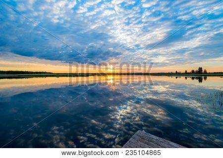 Beautiful Reflection Of The Sky In The Calm Surface Of The Lake In The Morning