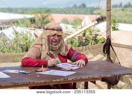 Goren, Israel, April 06, 2018 : A Participant In The Knight Festival Sits At The Table And Paints A 