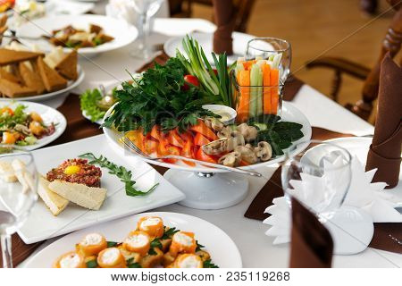 Salad With Vegetables And Greens On Wooden Table