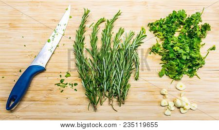 Thyme And Parley Placed On The Wooden Desk With Knife. Fresh And Healthy Plants Prepared For Cooking