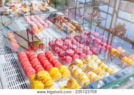 Assortment Of Colorful Macaroons On Cafe Showcase. Variety Of Macaron Flavours. Sweet Almond Cakes I