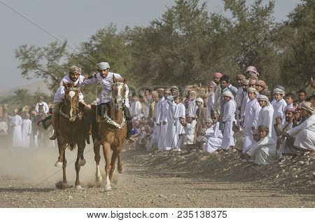 Ibri, Oman, April 7th, 2018: Omani Men Racing Horses In A Countryside Of Oman