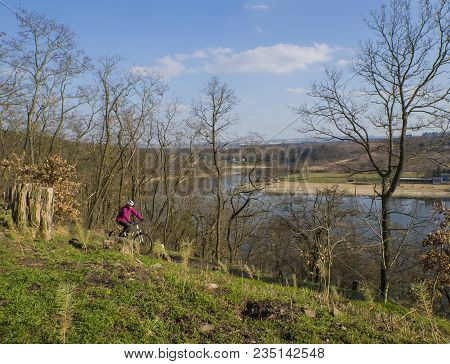 Czech Republic, Prague, Hostivarska Prehrada, April 2, 2018: Women In Pink Riding The Bike Around Ar