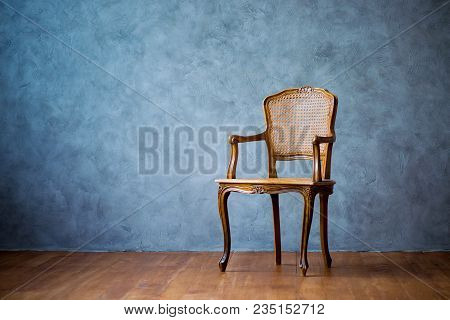 Old Chair On A Gray Wall Background