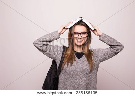 Female Student, Holding Book On Head. Isolated On White Background