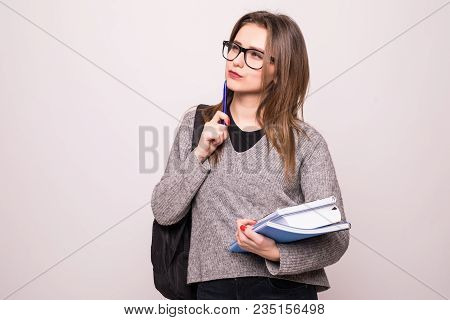 Portrait Of Cute Young Brunette Student Holding Exercise Books.