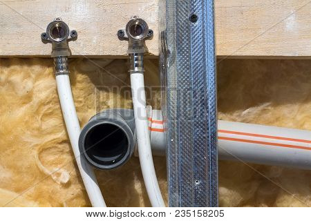 Water Pipes Made Of Polypropylene In The Wall, Plumbing In The House. Installation Of Sewer Pipes In