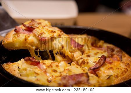 Hot Pizza Slice With Melting Cheese On A  Table In Restaurant Pizza Italian Food.