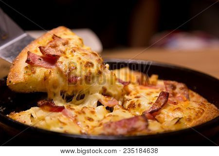 Hot Pizza Slice With Melting Cheese On A  Table In Restaurant Pizza Italian Food.