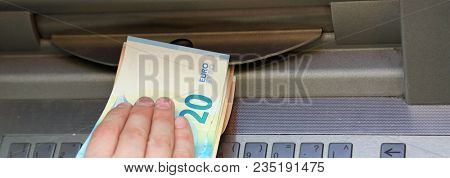 Hand Withdraws Money From An Atm With Euro Currency