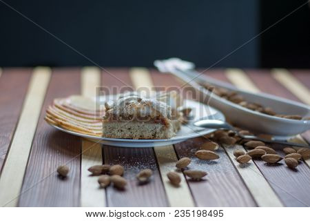 Square Shape Sliced Omemade Apple Pie With Kumquats And Almonds