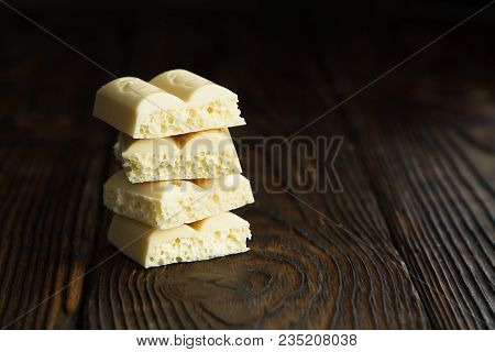 Pyramid Of White Porous Chocolate On A Wooden Vintage Old Background In The Style Of Moodle