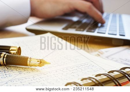 Financial Accounting. Accountant Work On A Laptop And Ledger In An Office.