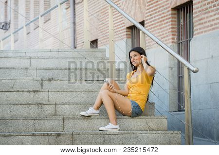 Attractive Latin Woman Listening To Music On Her Smart Phone