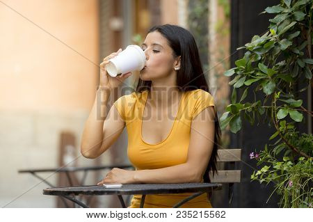 Attractive Latin Woman Sitting Drinking Coffee