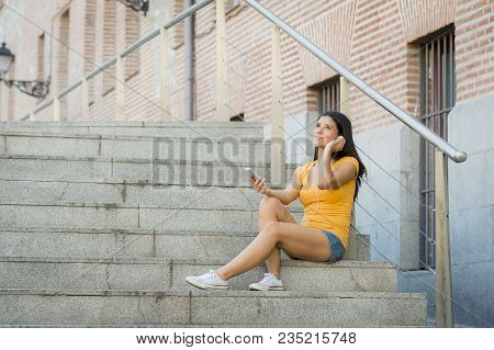 Attractive Latin Woman Listening To Music On Her Smart Phone